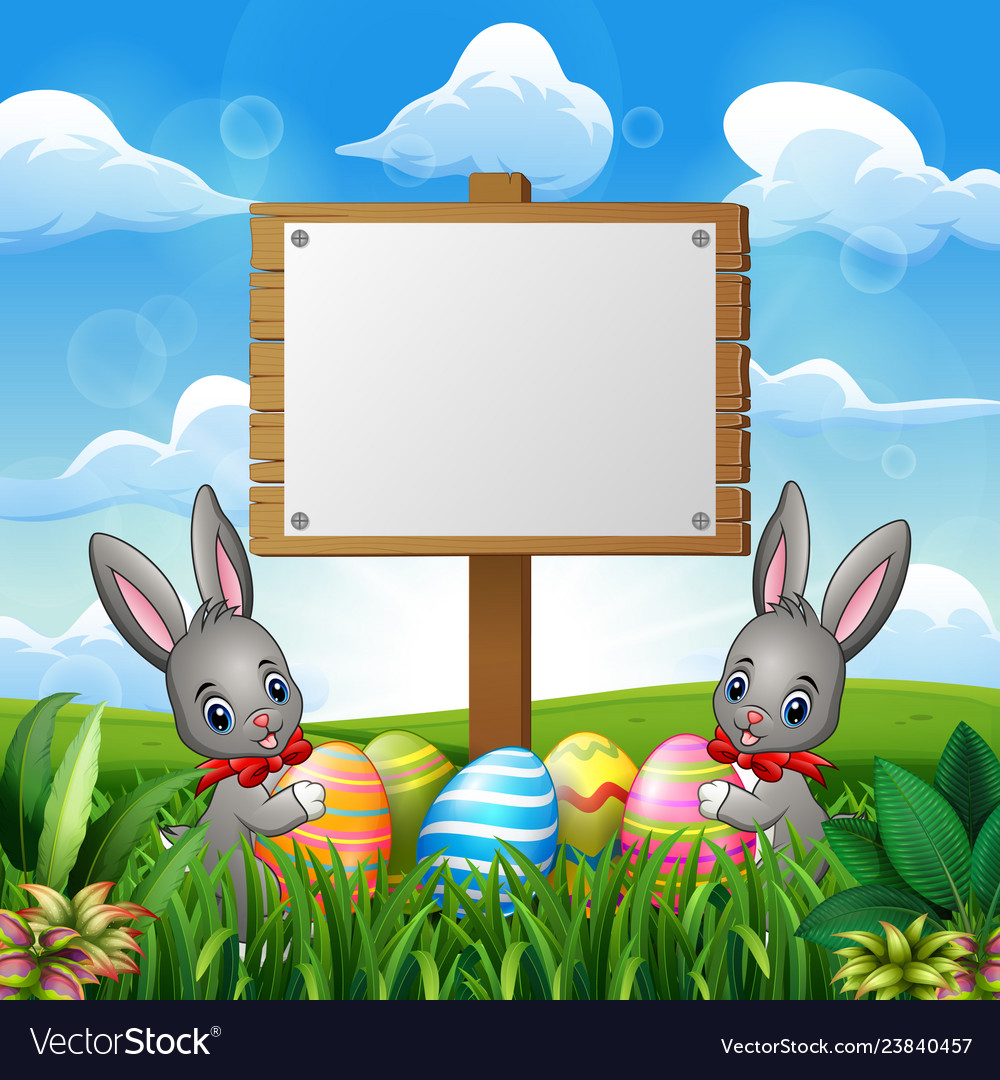 Easter bunnies with eggs and blank sign on the fie