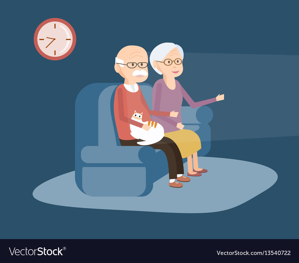 Elderly Couple Sitting On The Sofa And Watching Tv
