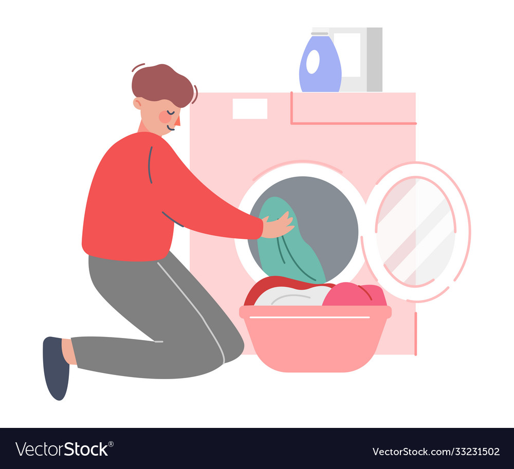 Young man putting dirty clothes in washing machine