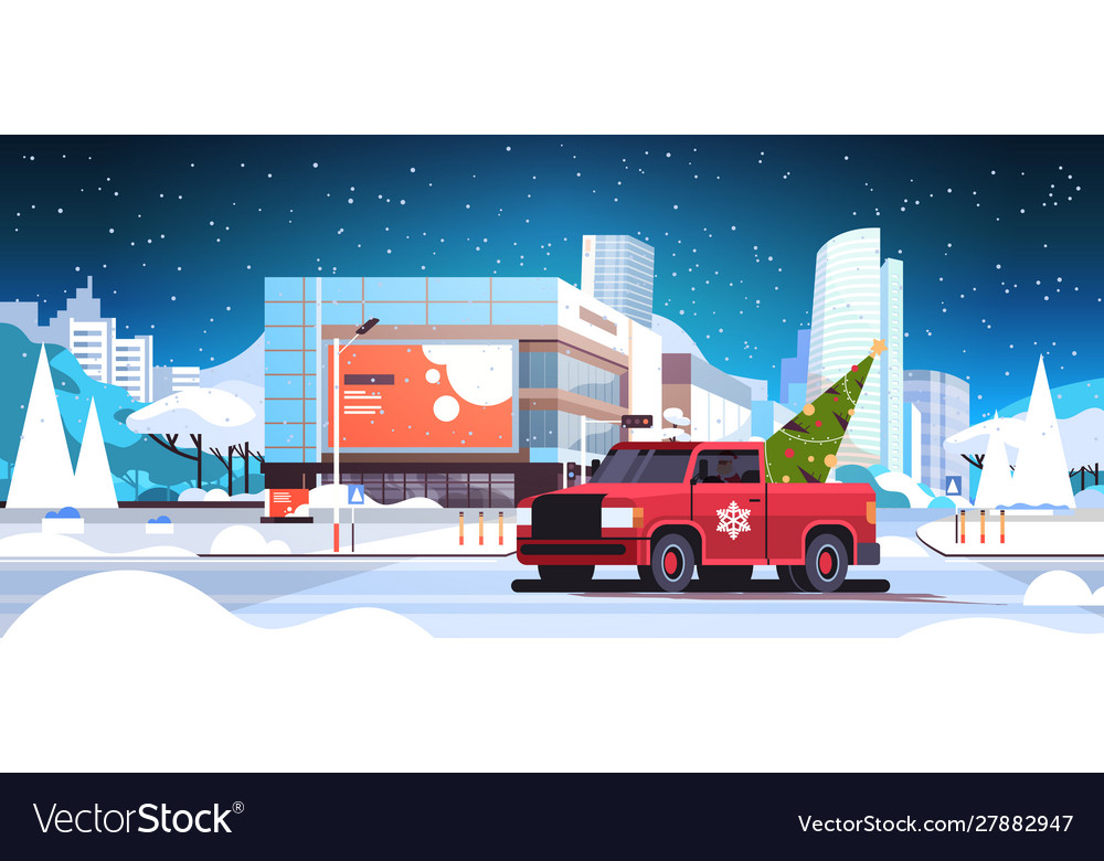 Santa claus driving red pickup car with fir tree