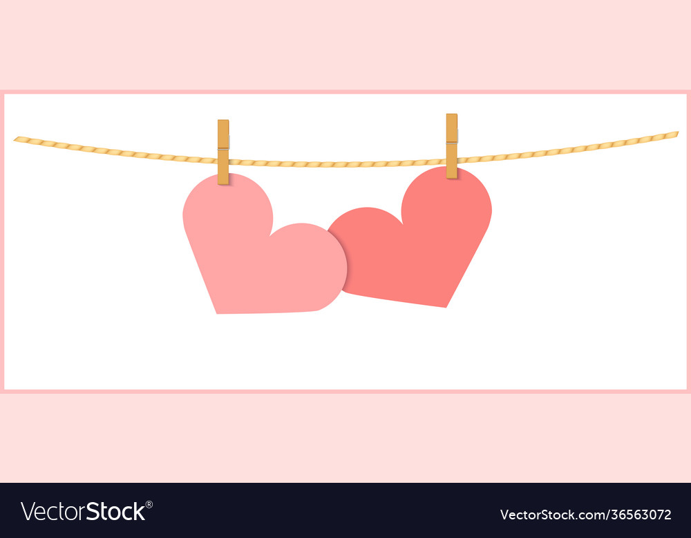 Two heart shape pink papers on string isolated