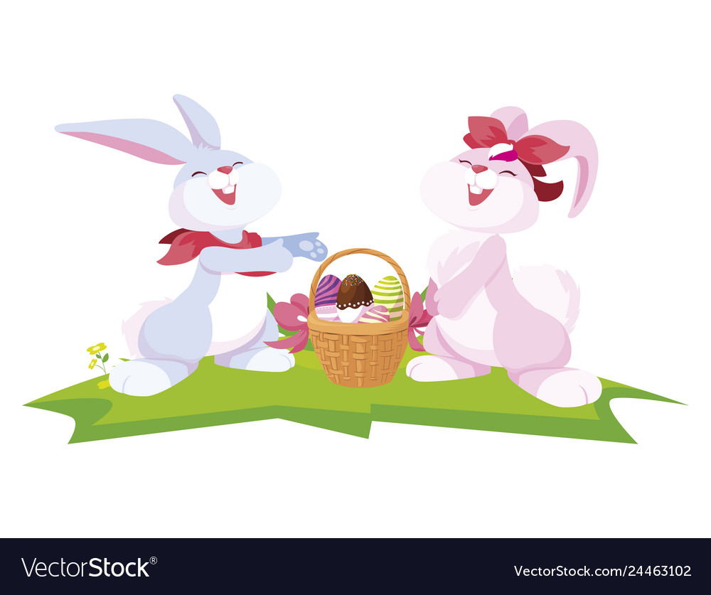 Cute rabbits couple with eggs painted in basket