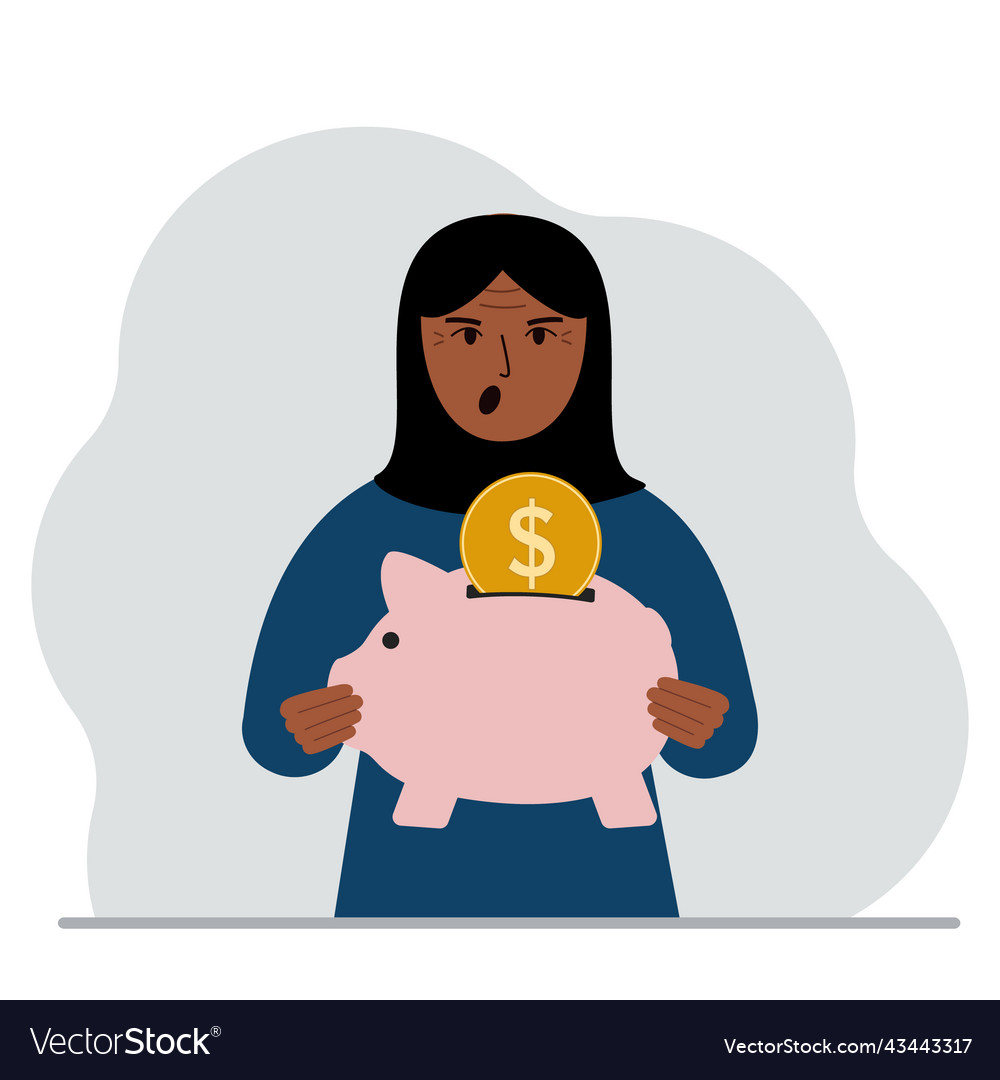 Happy muslim woman holds a piggy bank coin