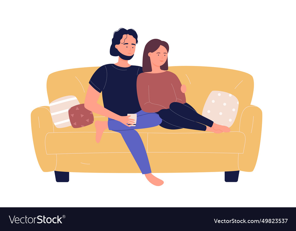 Young family couple sitting on sofa and watching