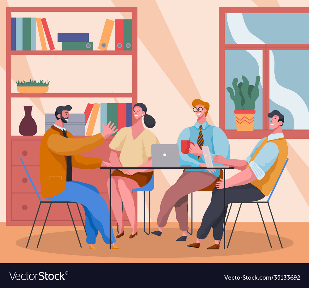 Communicating office workers sitting at table