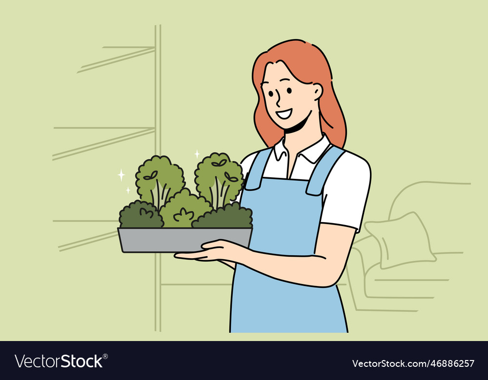 Smiling woman with microgreen container in hands