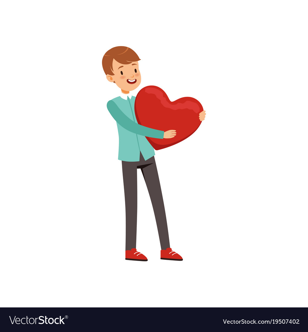 Smiling teen boy holding red heart happy