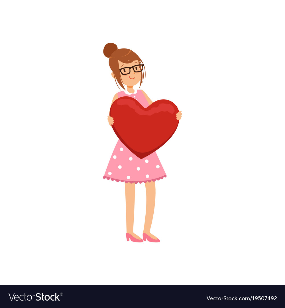 Pretty teen girl holding red heart happy