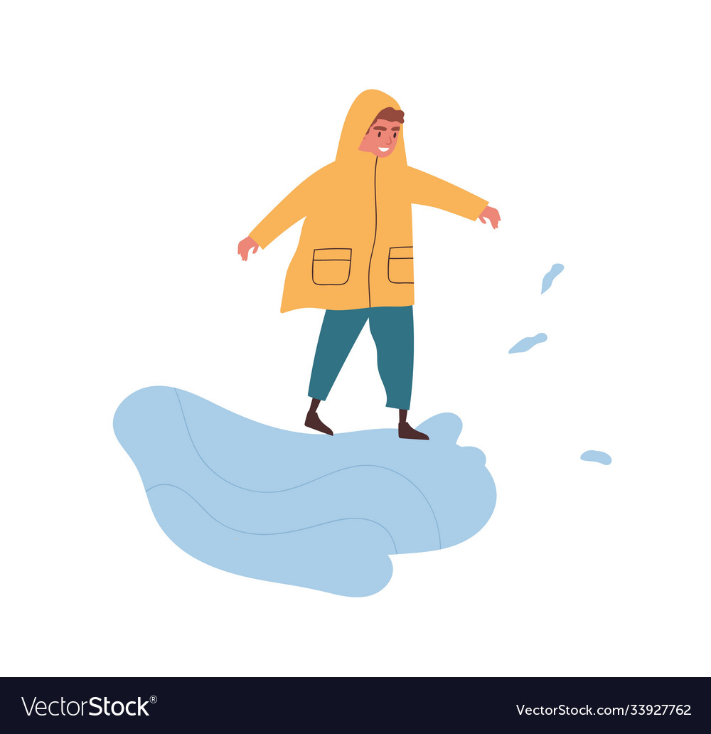 Funny boy in raincoat playing puddle enjoying