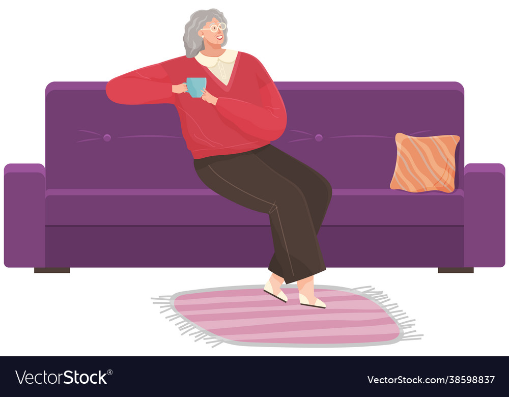 Adult woman sitting on couch at home drinking