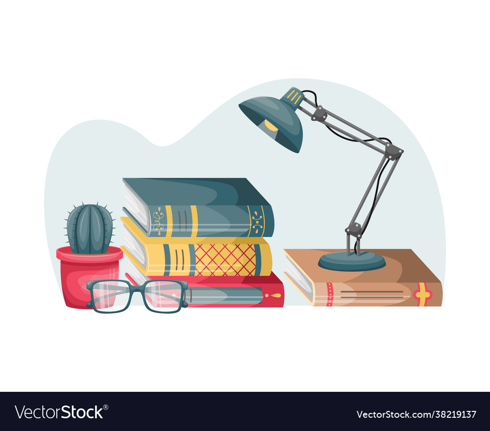 A stack books on table with reading lamp