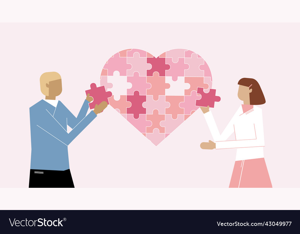 Couple assembling heart symbol from puzzle pieces