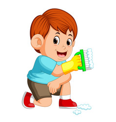 Boy using the red clotheis holding the broom Vector Image