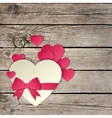 heart with a bow on wooden background vector image vector image