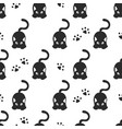 seamless pattern with black cats and cat paws vector image