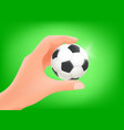 man holding soccer ball in a hand vector image