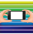 hands holding phone and colorful background vector image vector image