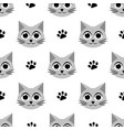 seamless pattern with cute cats and paw prints vector image