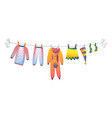 various items baby clothes on rope isolated vector image vector image