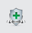 glass shield with silver frame with green cross vector image