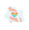 hands holding rainbow heart vector image