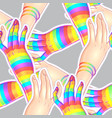 two women holding hands one hand with rainbow vector image vector image